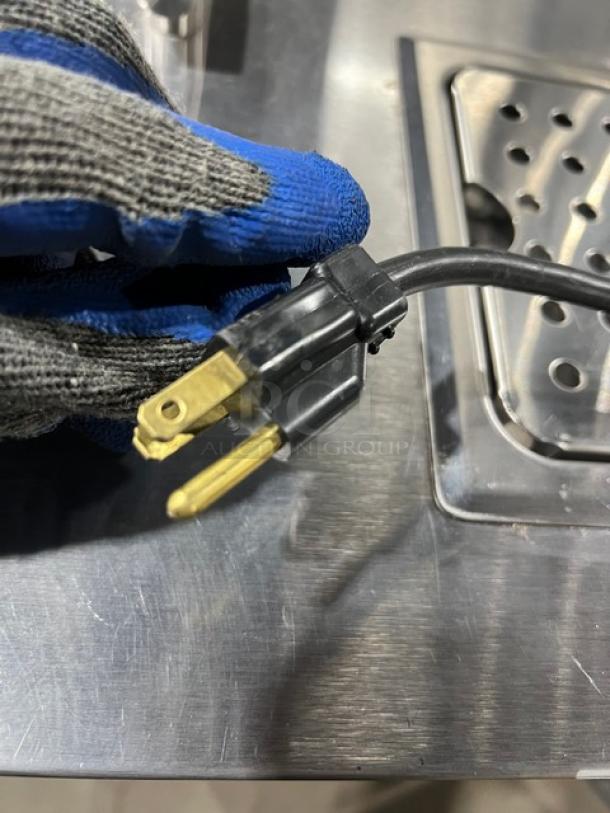 Micro Matic MDD-23 kegerator power plug on stainless steel worktop, showing 115V connection.