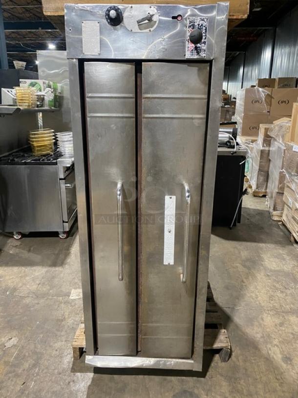 Bakers Pride stainless steel gas-powered single deck pizza oven, holds 5 pies. Features control knobs, visible wear.