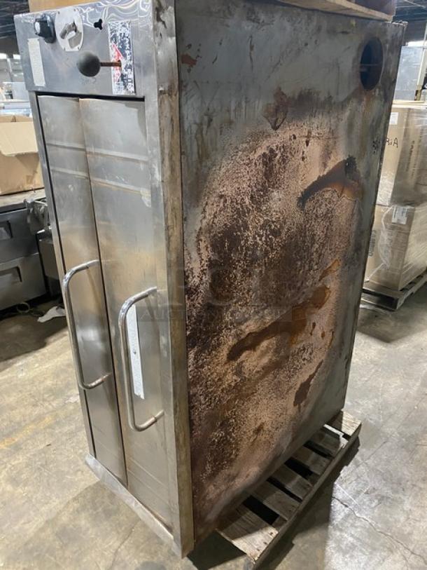 Bakers Pride stainless steel gas pizza oven, single deck, fits 5 pies, visible rust, used condition, industrial setting.