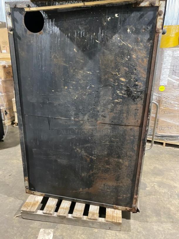 Bakers Pride stainless steel single deck gas pizza oven, well-used condition, visible wear, on a pallet.