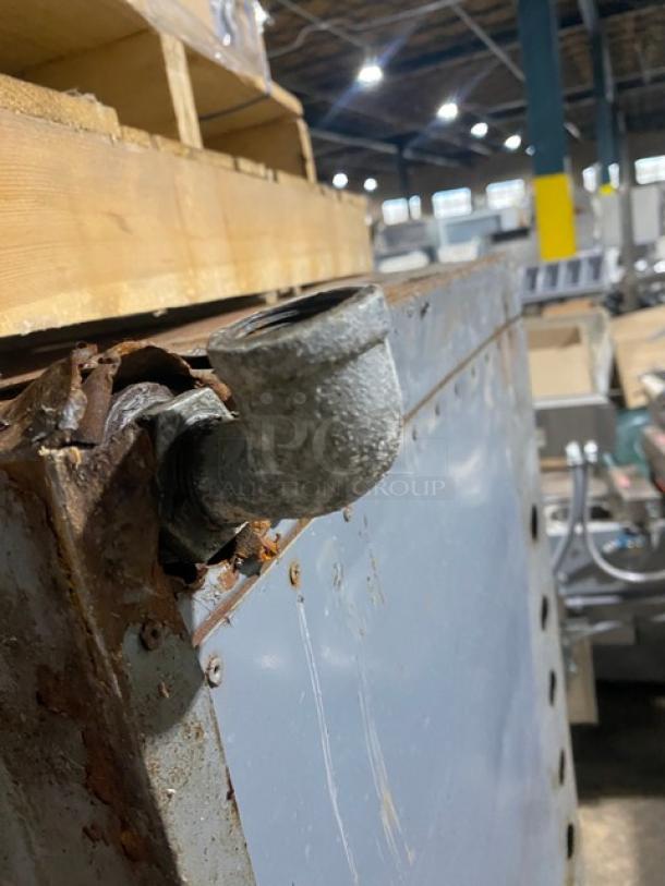 Bakers Pride stainless steel gas pizza oven, rusted surface, visible gas connection, single deck, for 5 pies.