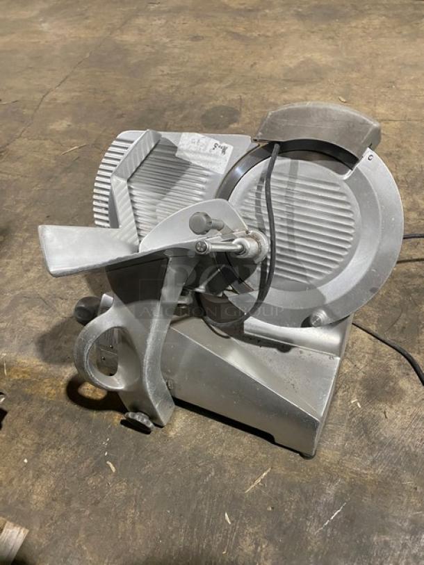Hobart EDGE commercial meat slicer, electric, countertop, angle feed, medium duty, 120V, on legs, model EDGE SN: 21-1005506.