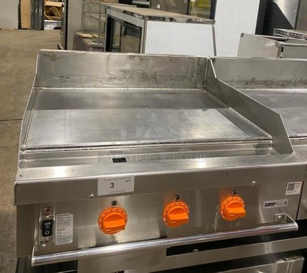 Woodstone 36" flat griddle, model WSGPL3636CT01NG, stainless steel, natural gas, with back and side splashes, on legs.