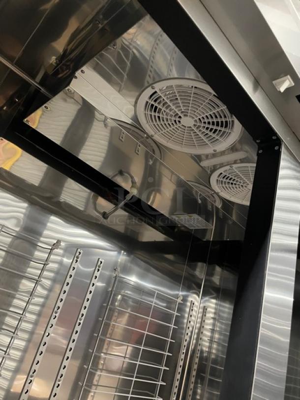 Blue Air BSF49-HC stainless steel reach-in freezer, interior view, showing shelves and ventilation. Slightly scratched, on casters.