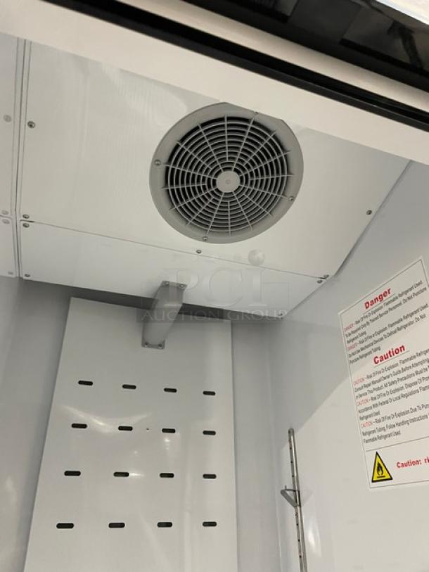 BLUE AIR BKGF23-HC glass door reach-in freezer interior view, serial KGF23HCX010274, with fan and caution labels visible.