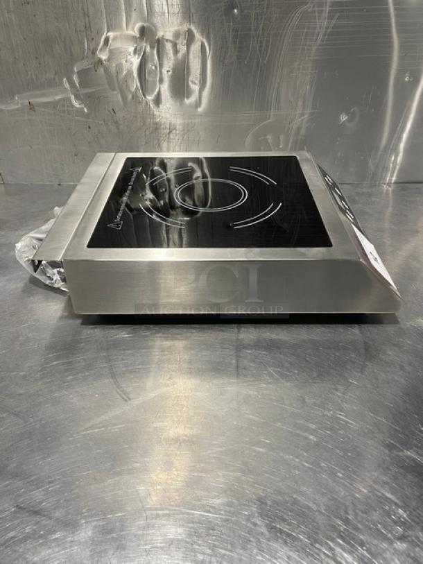 Adcraft INDB120V induction cooker, 2015 model with stainless steel body, new condition. Serial 12150270 displayed.