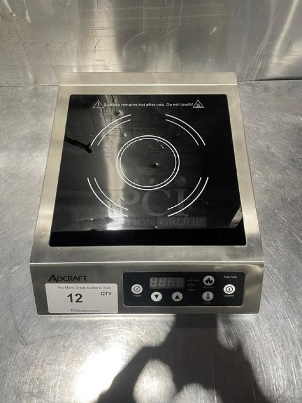 Adcraft INDB120V induction cooker with stainless steel body, digital display, and control buttons. New condition. Model 2015.