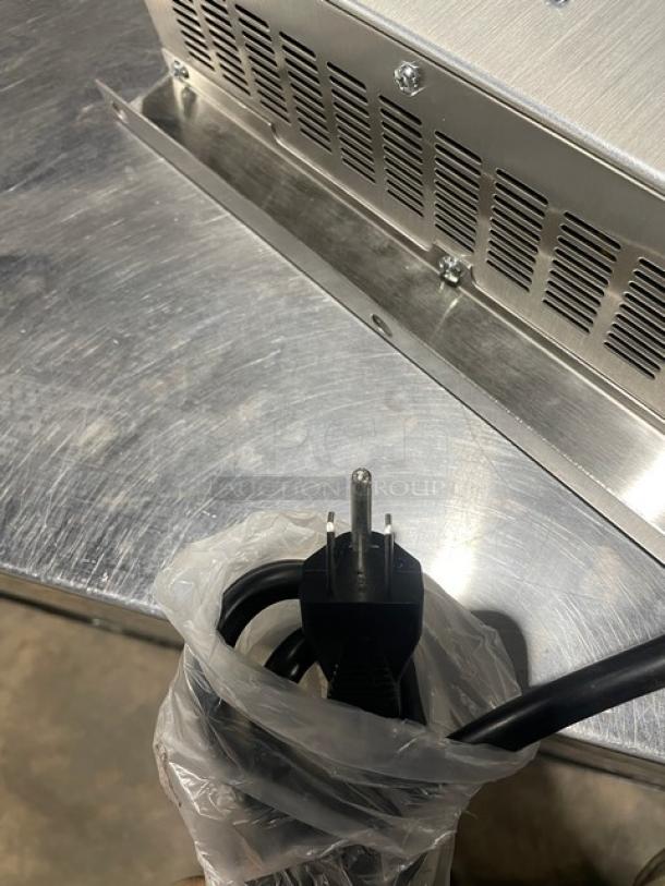 Adcraft INDB120V induction cooker with stainless steel body, power cord in plastic wrap, 2015 model, serial 12150270.