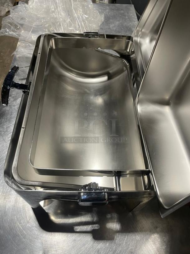 New stainless steel buffet chafing dish with handles and drop-in pan. Pristine condition, ideal for catering events.