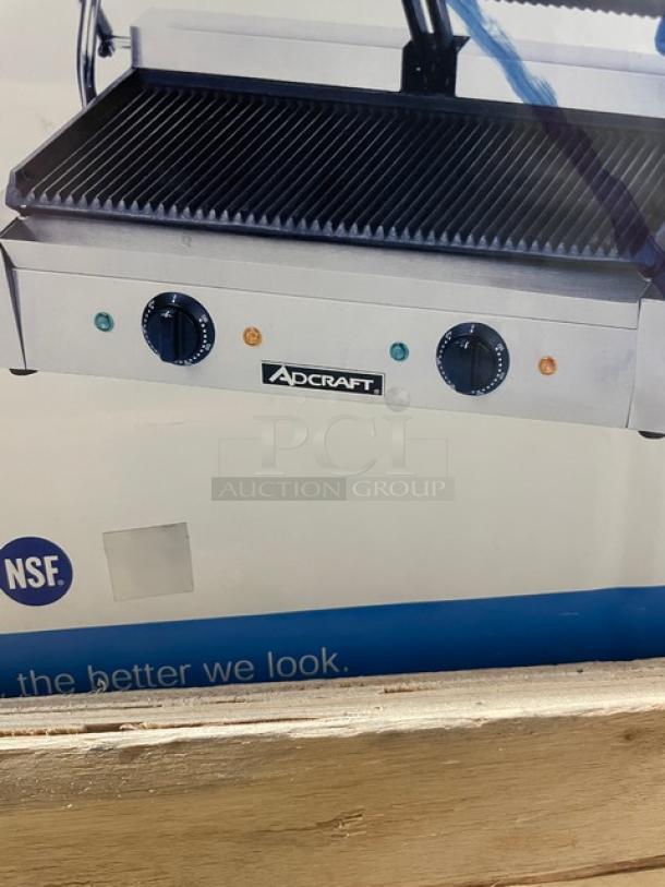 Adcraft SG-813 dual panini press, new in crate. Stainless steel with cast iron grooved plates, separate temperature controls, 120V.
