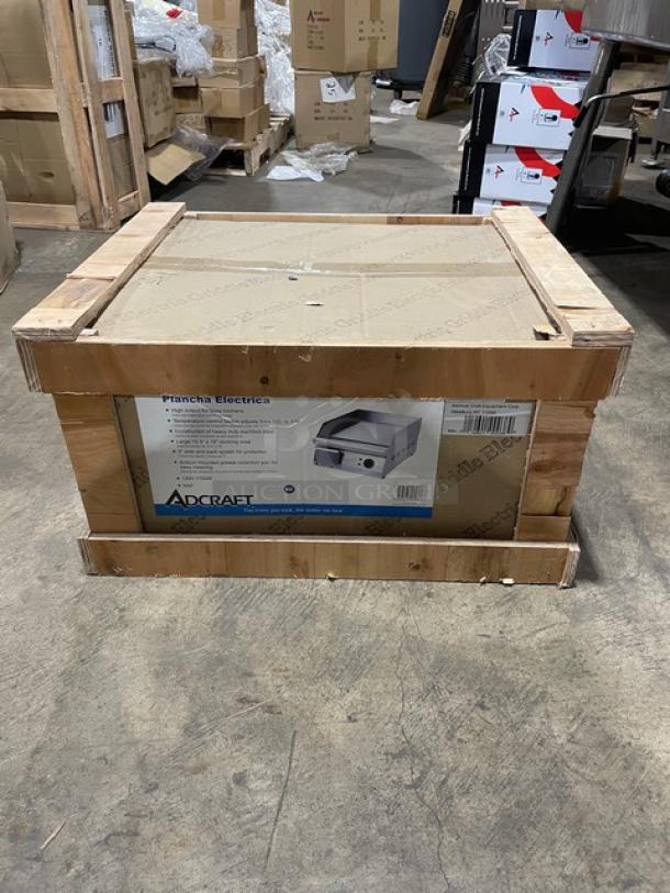 New in crate Adcraft 16" electric flat griddle, stainless steel, 120V, with back and side splashes, sealed packaging.