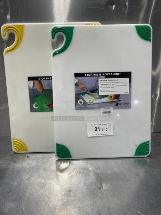 Brand new San Jamar Saf-T-Grip cutting boards with non-slip corners. Includes two boards, one with green corners and one with yellow.