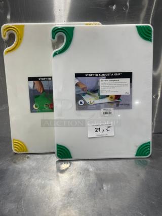 Brand new San Jamar Saf-T-Grip cutting boards with non-slip corners. Includes two boards, one with green corners and one with yellow.