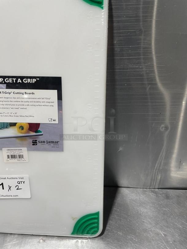 Brand new San Jamar Saf-T-Grip cutting board with green corners, non-slip surface, and measurement markings.