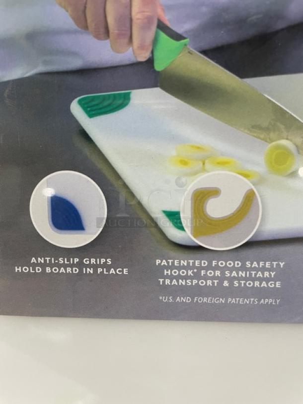 Brand new San Jamar Saf-T-Grip cutting board with anti-slip grips and patented food safety hook for sanitary storage.