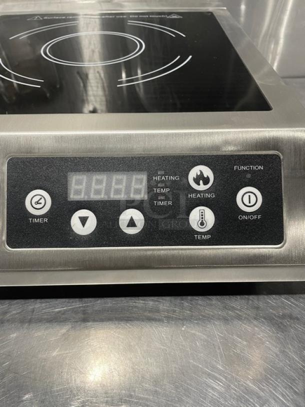 Adcraft INDB120V induction cooker, stainless steel, digital controls, new condition, model and serial labels visible.