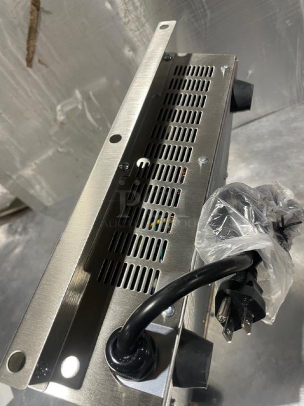 Adcraft INDB120V induction cooker, 2015 model, all stainless steel, new condition, visible power cord and ventilation grilles.