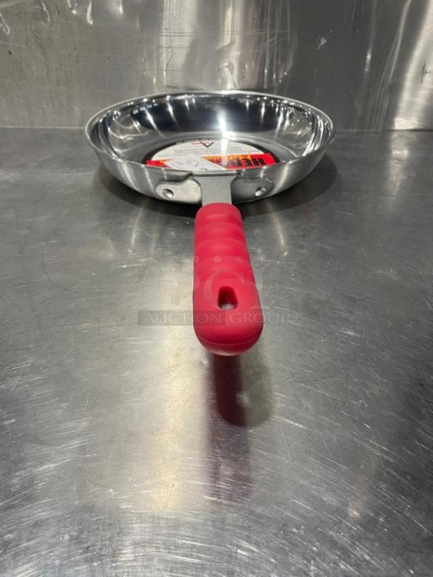 Adcraft aluminum frying pan, model HER-12FP/4, with red rubber grip handle, new condition.