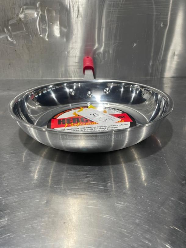 New Adcraft HER-12FP/4 aluminum frying pan with rubber grip handle, polished finish, visible label inside.