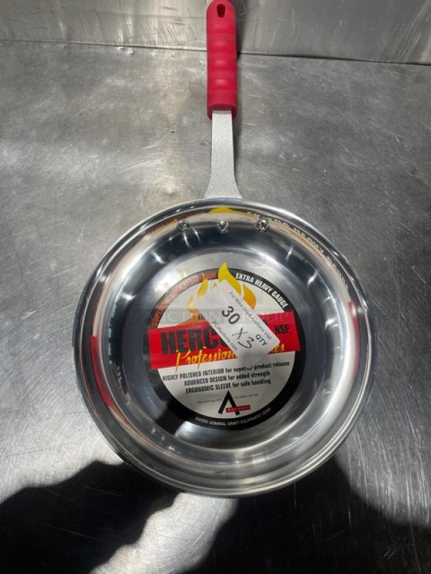 Adcraft HER-12FP/4 aluminum frying pan with rubber grip handle, new condition. Label indicates NSF certification.