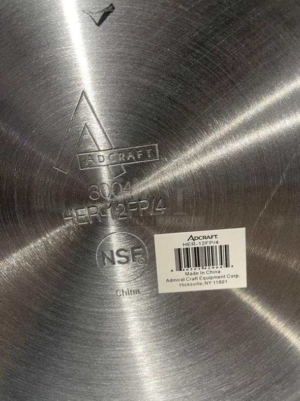 Adcraft HER-12FP/4 aluminum frying pan with rubber grip handle. Features marked NSF, 3004, and Made in China. New condition.