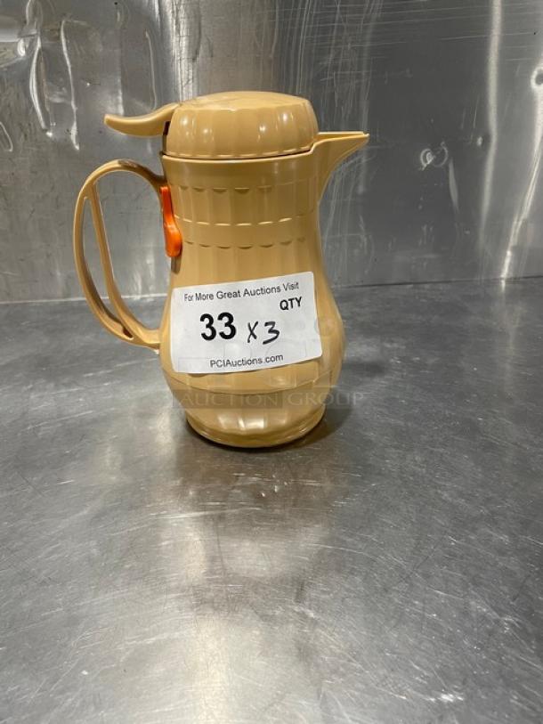 Service Ideas insulated ABS plastic coffee carafe with push button lid, beige color, new condition, listing label indicates "33 x 3."