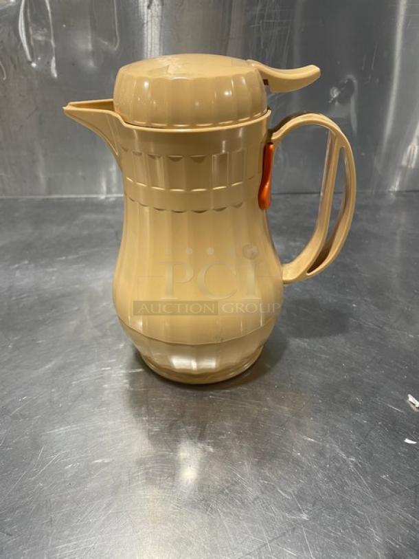 Service Ideas insulated ABS plastic coffee carafe, new condition, beige with push-button lid, ergonomic handle.