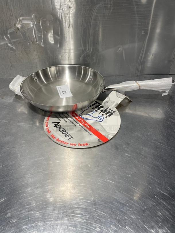 New Adcraft Titan Series 12" frying pan, model FPSI-12, stainless steel, with original tags and protective packaging.
