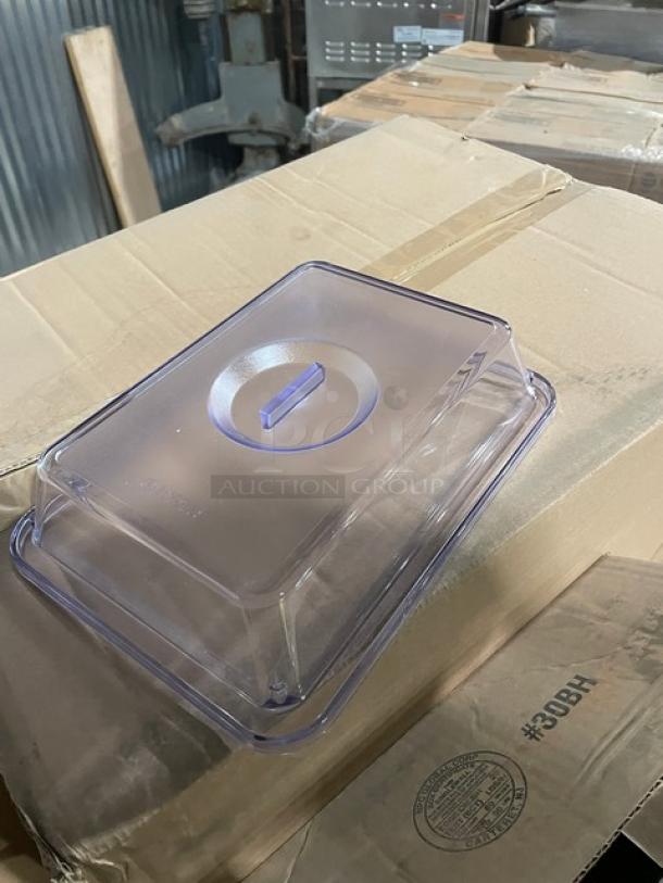 Mixed pallet of commercial kitchen items, including Steelite and G.E.T. porcelain pieces, on a cardboard box.