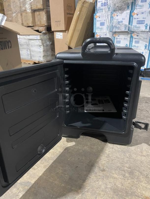 Brand new Cambro Ultra Camcarrier black insulated food pan carrier, front-loading, commercial use, open door view.