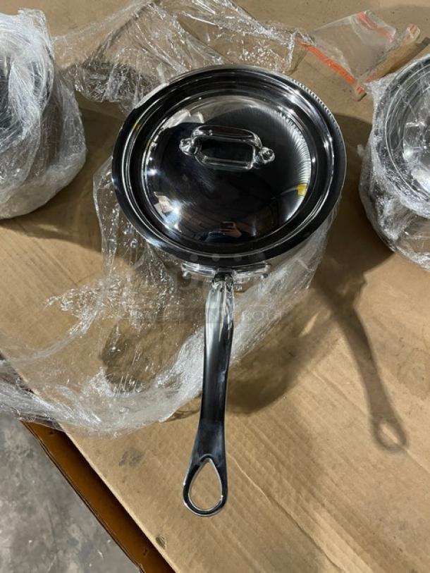 Brand new Mauviel M'Cook 5-ply stainless steel saucepan with lid, cast handle, shown wrapped, excellent condition.