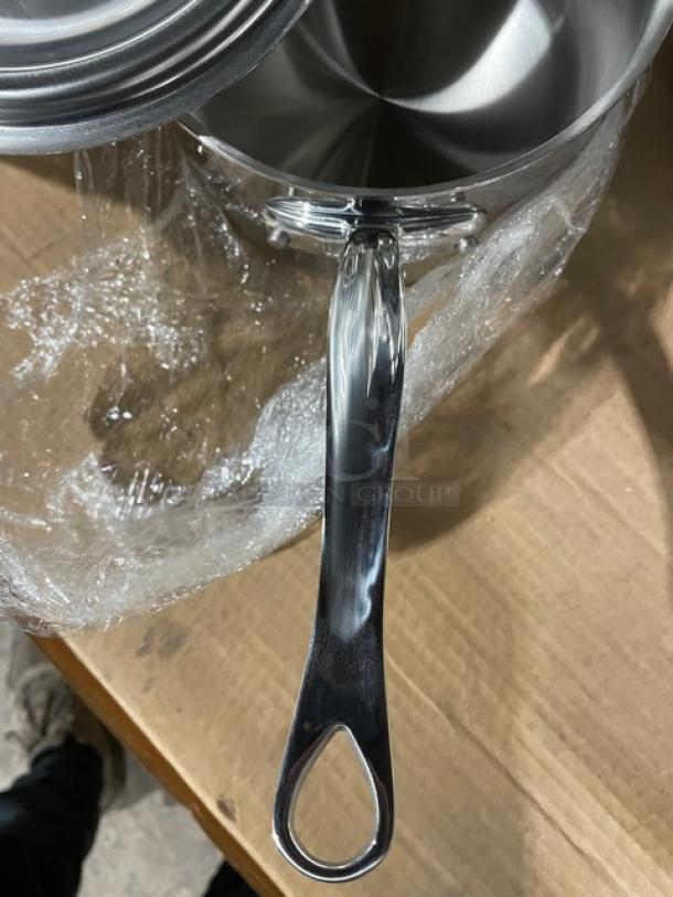 Brand new Mauviel M'Cook 5-ply stainless steel saucepan with lid, cast handle, pristine condition, wrapped in protective plastic.