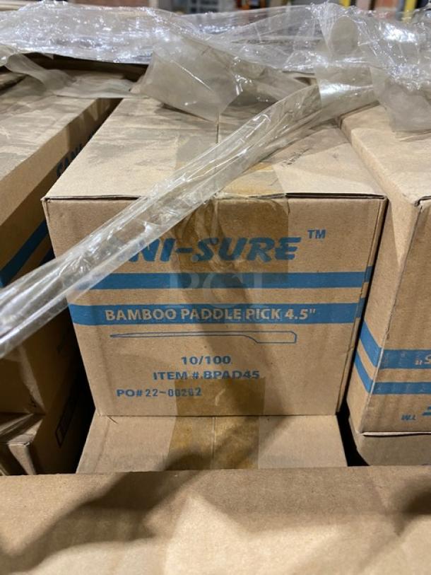Boxes of Sani-Sure Bamboo Paddle Picks, 4.5", model BPAD45, stacked on a pallet, labeled as 10/100, PO# 22-02622.