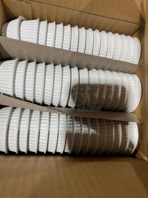 Box of white fluted ramekins, 2 oz each, stacked in rows. Carlisle Model 084402, new condition.