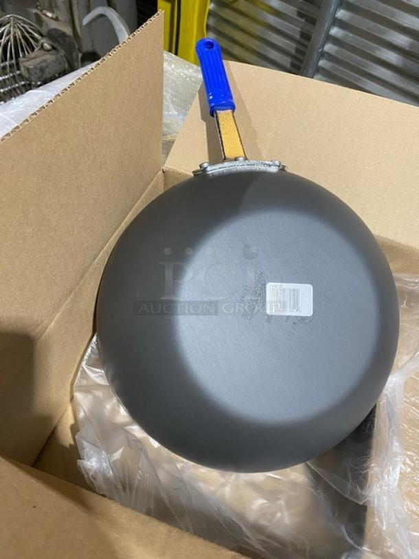 Brand new Vollrath Wear-Ever Series 11-1/2" aluminum stir fry pan, model H4015, with blue grip handle, in package.