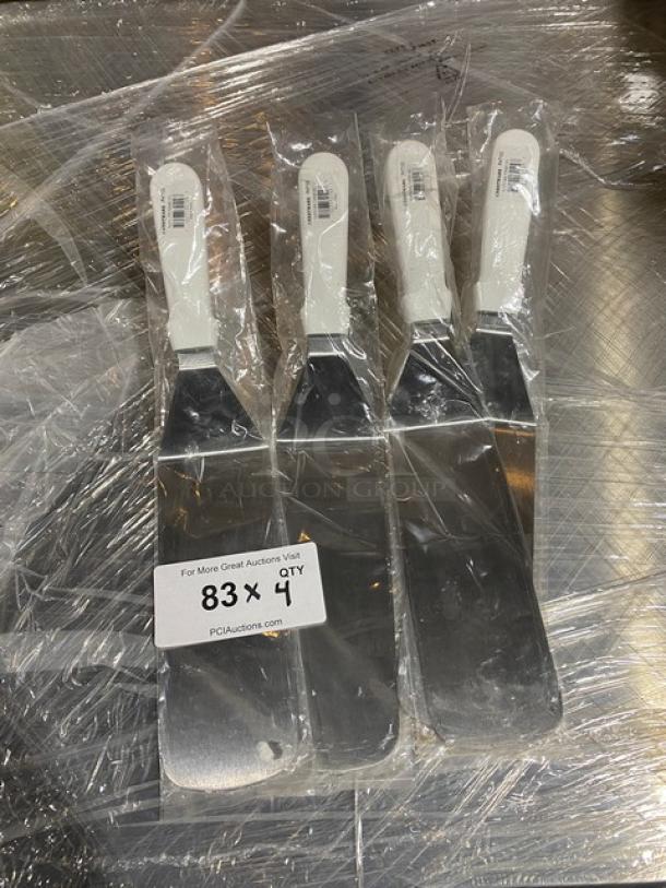 Four brand new Crestware PHT103 10" stainless steel turners with white grip handles, sealed packaging, auction lot of four.