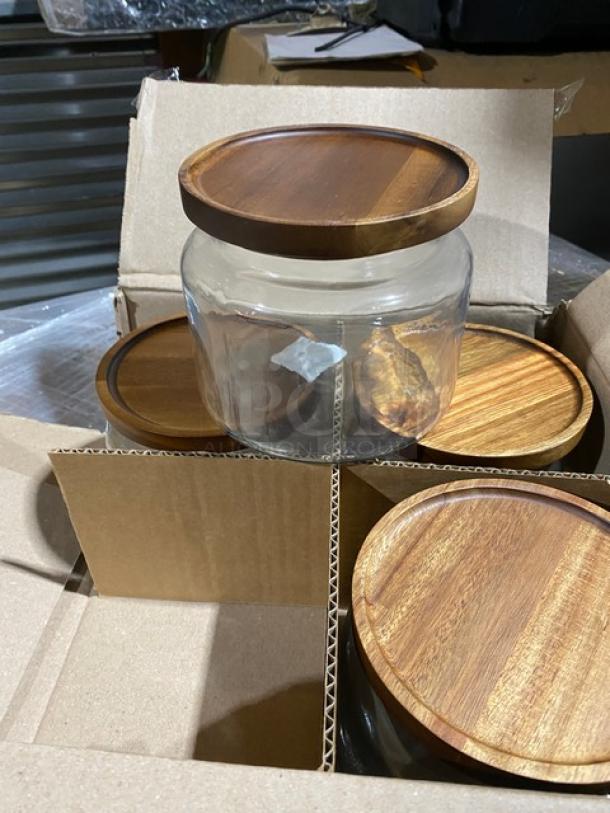 Brand new Anchor Hocking 48 oz. Mini Montana Glass Jars, model 97692AHG17, with acacia wooden lids, 4 per case.