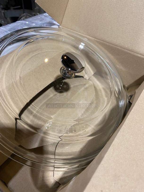 Brand new Staub W4208 glass lid, clear domed style, features chrome handle, Staub logo etched, in original packaging.