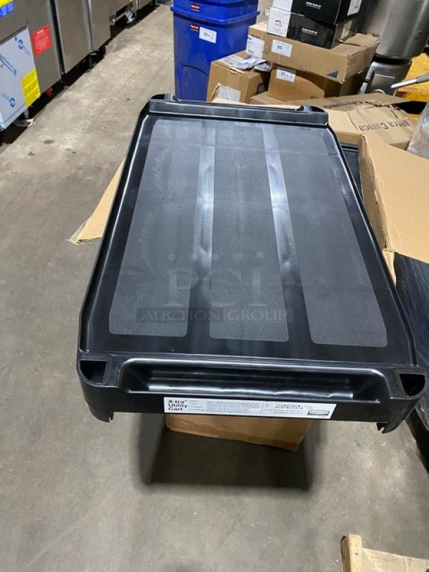 Rubbermaid Commercial black 3-tier bus cart, model D714091. Open sides, 300 lb capacity, brand new condition.