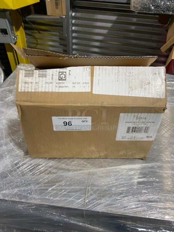 Brand new San Jamar P7500 Stainless Steel 3-Well Condiment Pump Service Center in box with labels and markings visible.