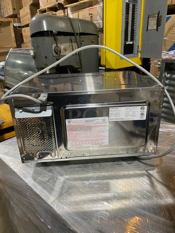 Amana RMS10TSA 1000W stainless steel commercial microwave. Digital controls, 120V, on legs. New condition, back view.