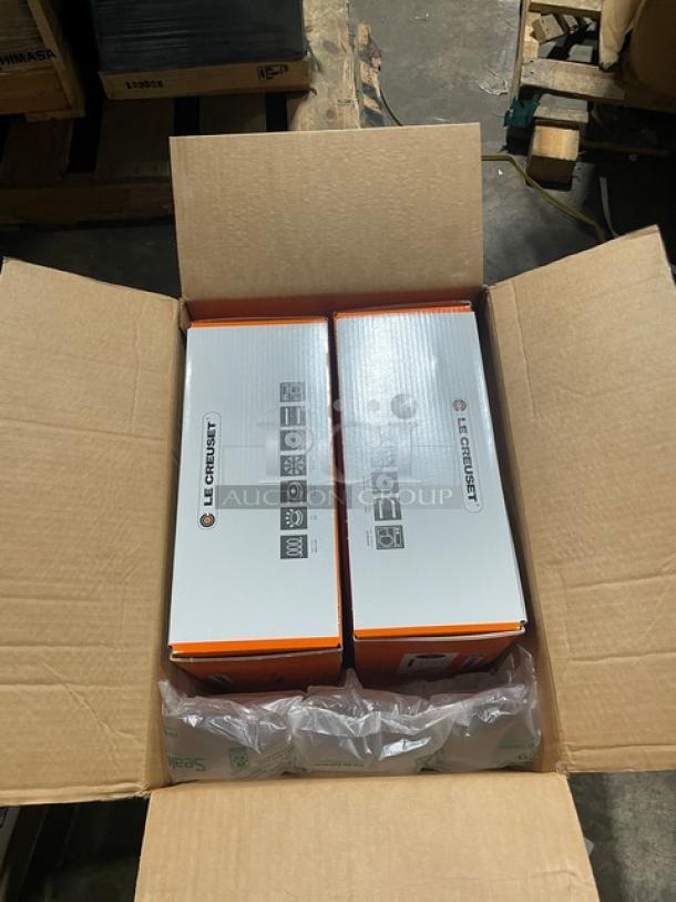 Two boxed Le Creuset Stoneware Dutch Ovens in a shipping box. Brand new, commercial-grade, 6.75 Qt, enameled cast iron.