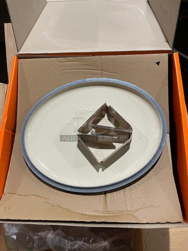 Brand new Le Creuset 6.75 Qt. Oval Signature Dutch Oven in oyster. Features enameled cast iron, handles, and stainless steel knob.