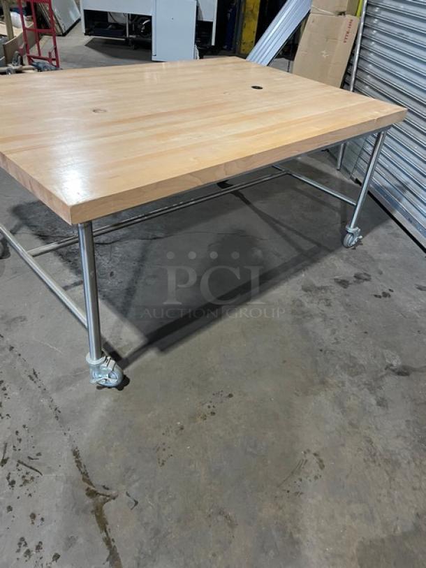Lightly used commercial wooden butcher-block style worktop, 72"x48", on metal casters, excellent condition.