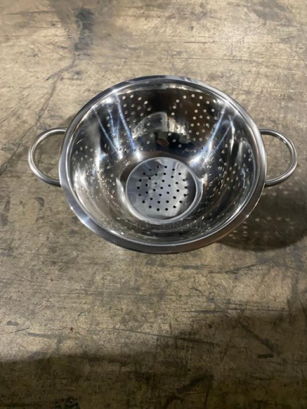 Brand new ABC stainless steel perforated colander with handles, durable construction, polished finish, excellent condition.