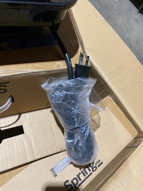 Brand new Spring USA SM-300CR black induction warmer, 120V, with wrapped power cord, shown in original packaging.