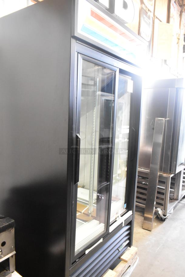 Brand new True GDM-33-HC-LD commercial cooler with two glass doors, poly-coated racks, minor scratches, 115V, 1 phase.