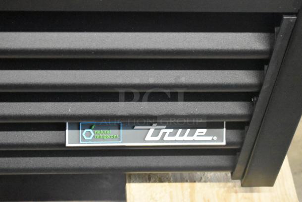 BRAND NEW 2025 True GDM-33-HC-LD commercial cooler with minor scratches. Features poly coated racks, 115V, 1 Phase. Label shows "natural refrigerant" and True logo.