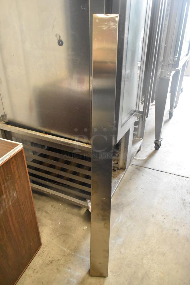 2019 Rational SCC WE 62 Combi Convection Oven in stainless steel with UltraVent Plus hood on double pan rack stand.