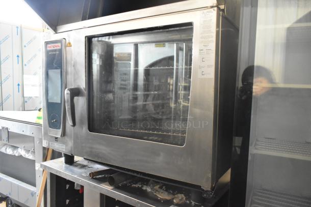 2019 Rational SCC WE 62 Combi Convection Oven, stainless steel, with UltraVent Plus hood on double pan rack stand.